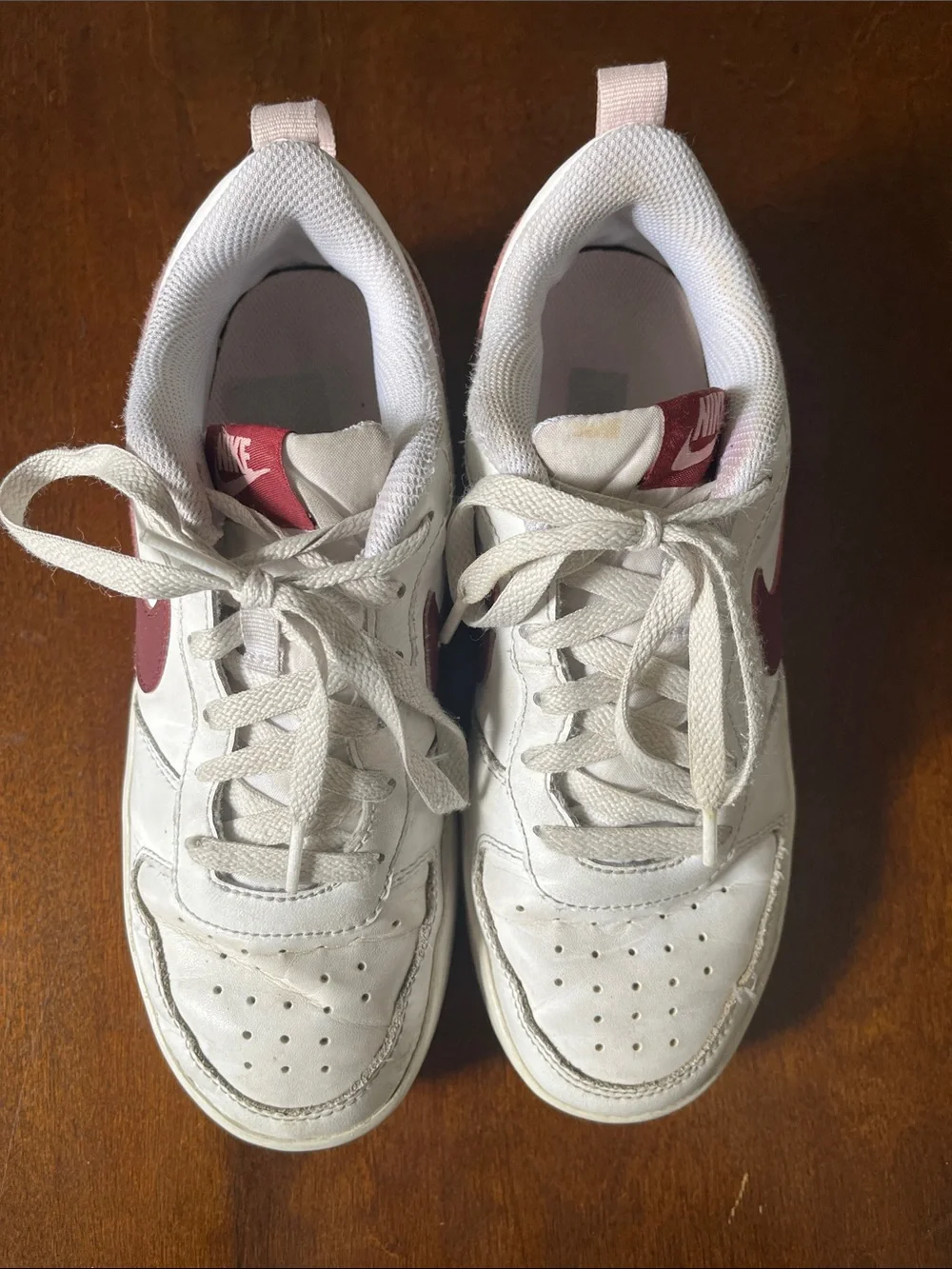 Nike Kids White Sneakers with Maroon Swoosh and Light Pink Details